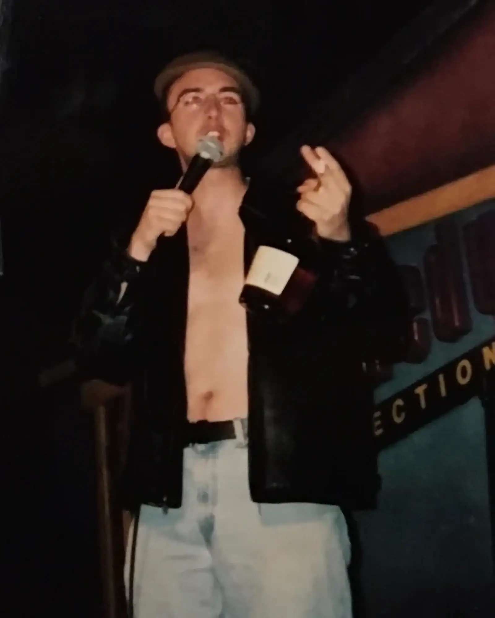 Shirtless Joe in a Leather Jacket Performing Stand-Up with a Bottle of Cognac | Joe List | Tuesdays with Stories Comedian Joe List of Tuesdays with Stories performing stand-up comedy in a leather jacket with a bottle of cognac in his hand. Find more about Joe at www.tuesdayspod.com/joe-list