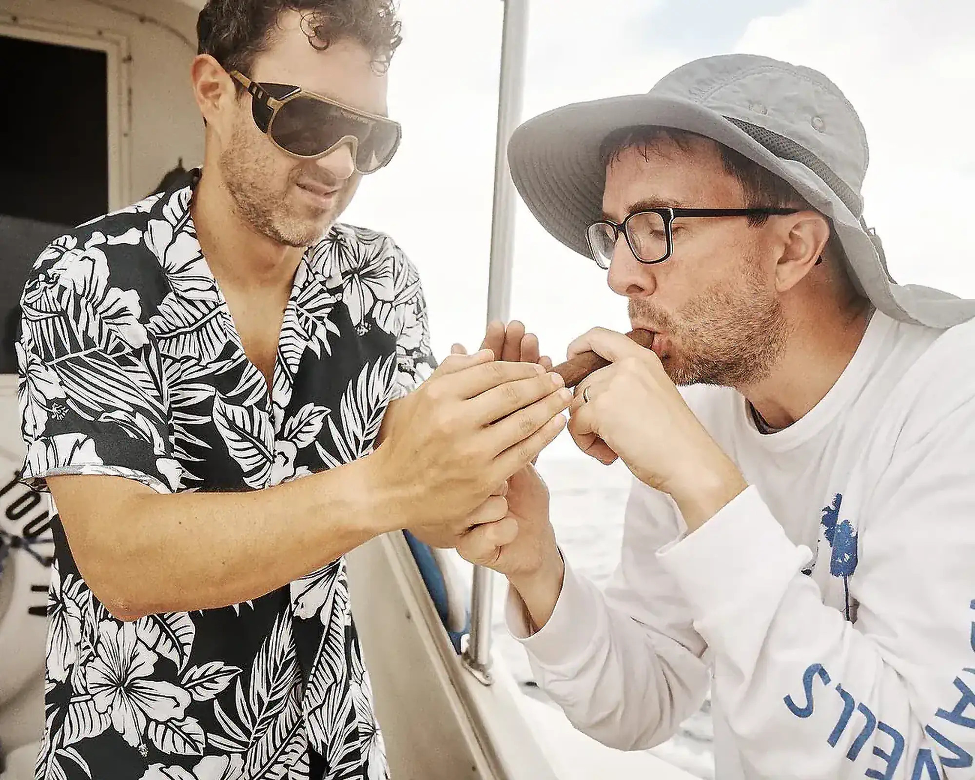 Mark and Joe Smoking a Cigar on the Fishing Boat | Mark Normand and Joe List | Tuesdays with Stories Comedians Mark Normand and Joe List of Tuesdays with Stories smoking a cigar on a fishing boat in the ocean. Find more Tuesdays with Stories photos at www.tuesdayspod.com/photos